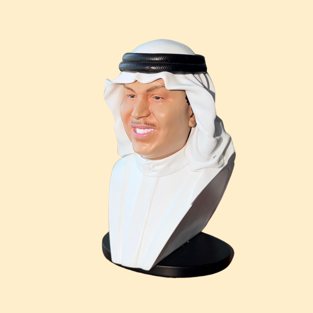 مجسم محمد عبده أبو نورة يرتدي ثوب أبيض زاوية جانبية تظهر ابتسامته